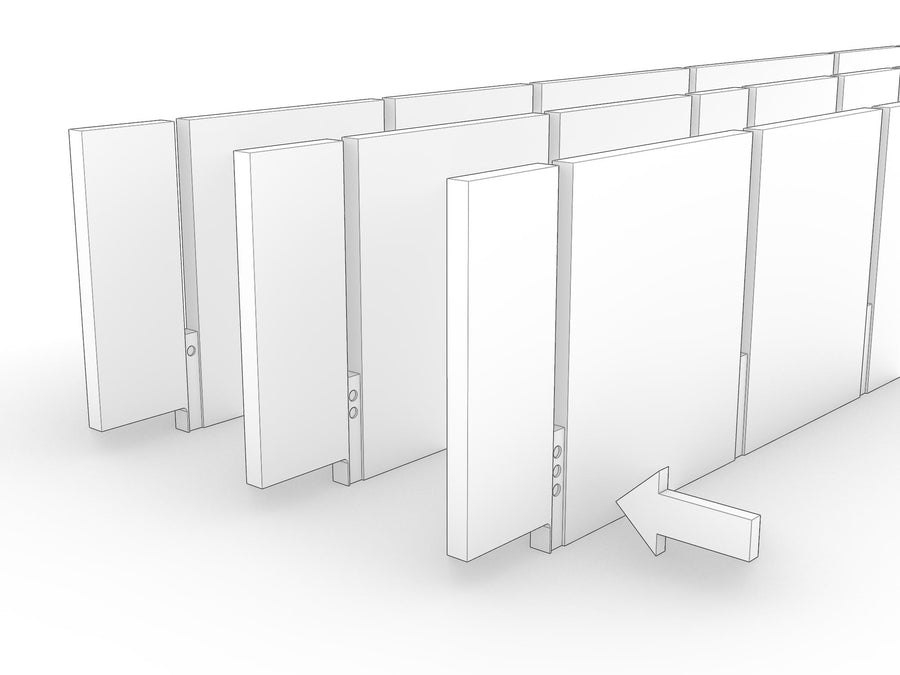 A row of uprights standing in order with dot markings visible in the bottom slots