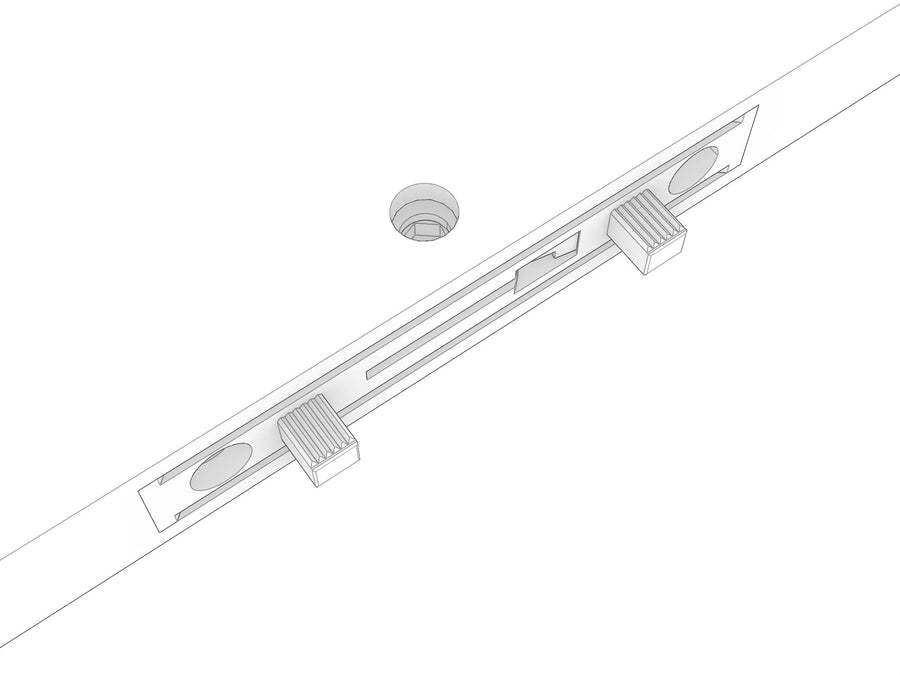 The end of a shelf showing two Lamello Clamex fittings machined into the panel, with the round Allen key access hole above